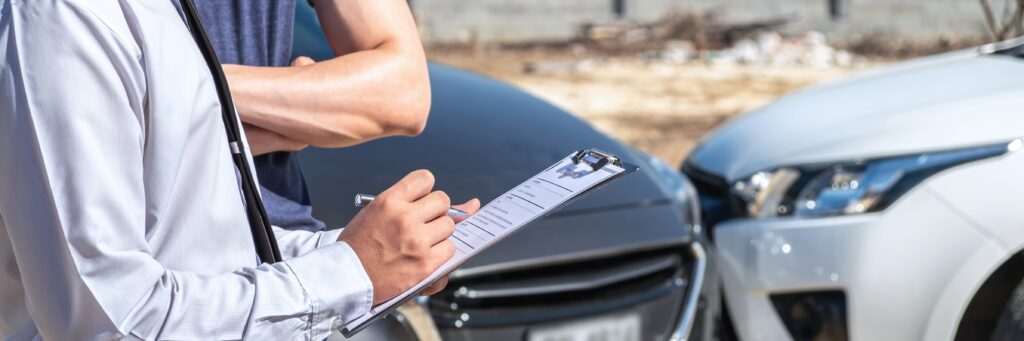 person performing insurance inspection after car collision 