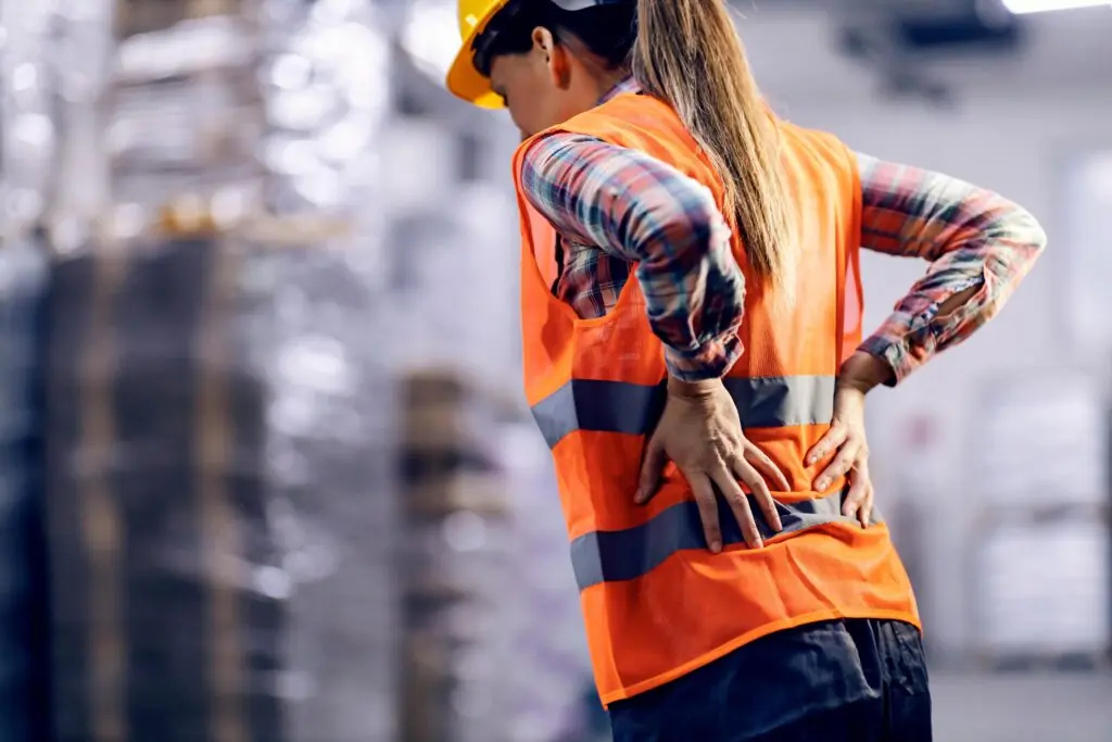 worker with their hands on their back