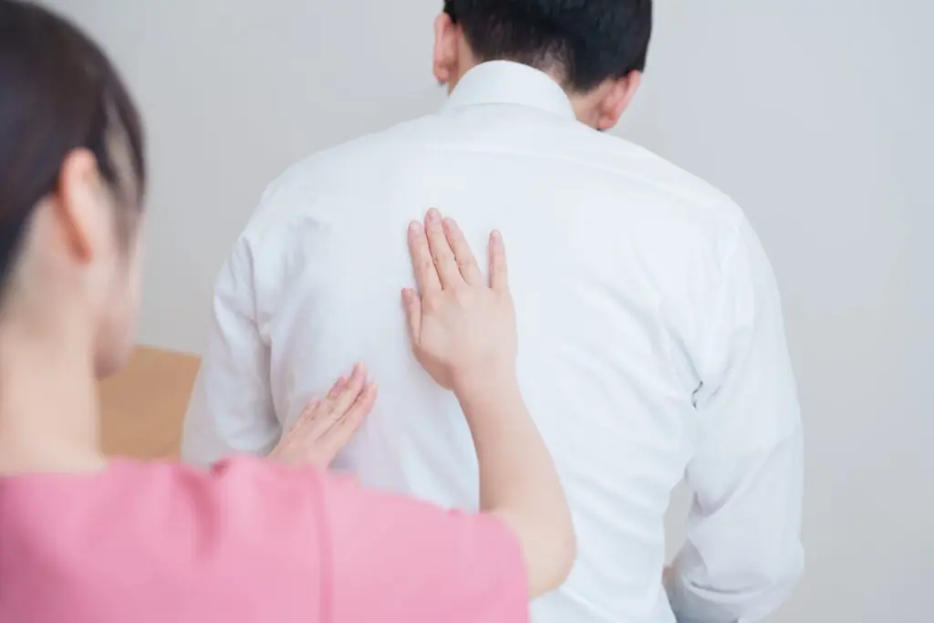 person inspecting another persons back