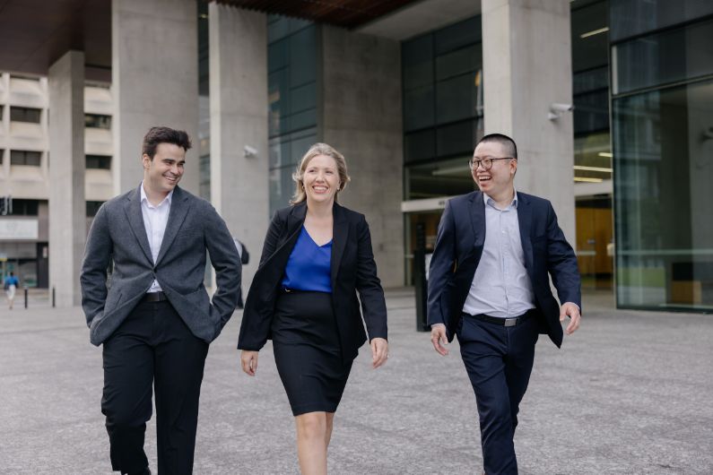 a group of lawyers walking outside a commercial building